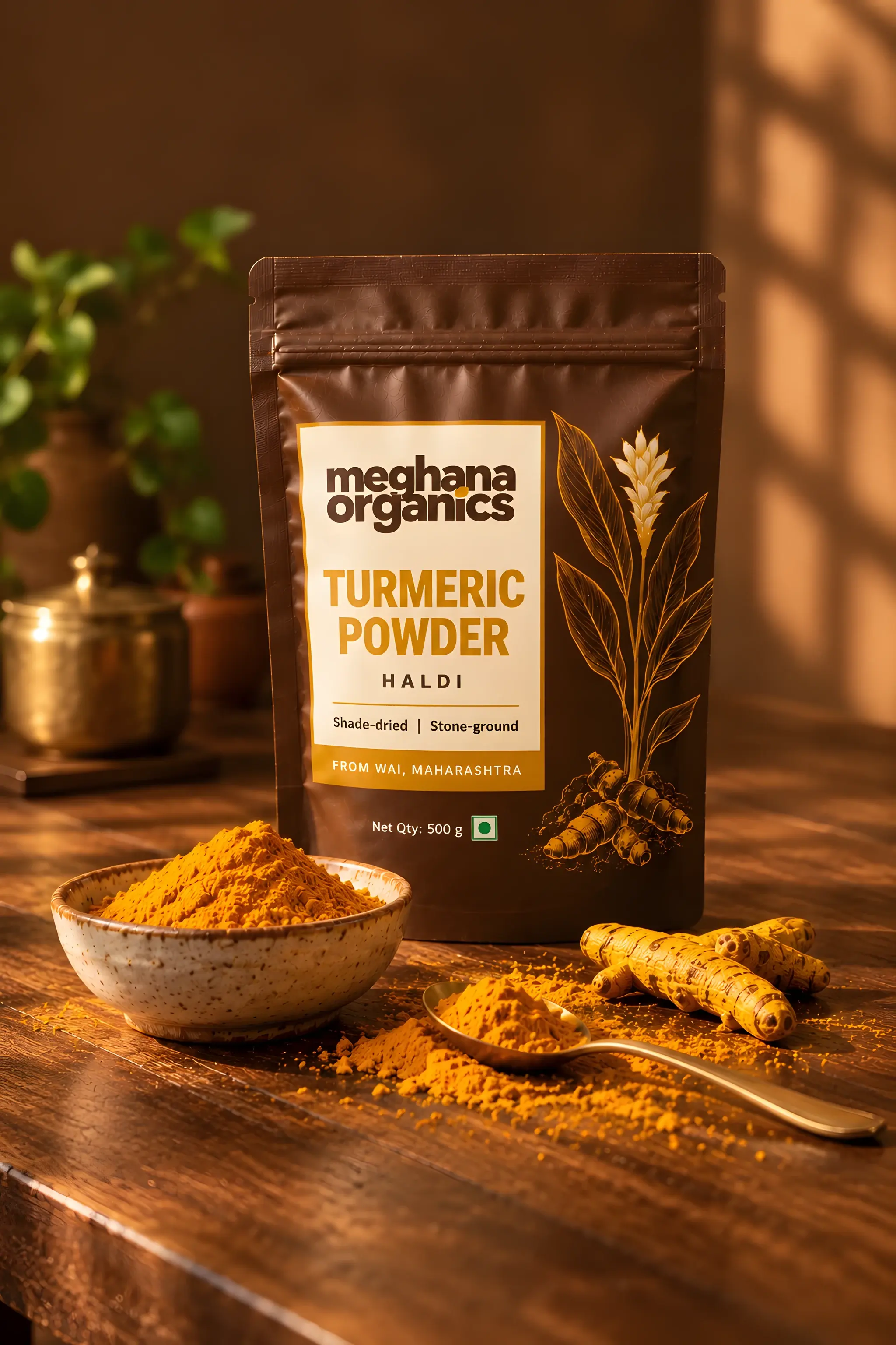 Meghana Organics turmeric powder pouch on a wooden table with a bowl of haldi